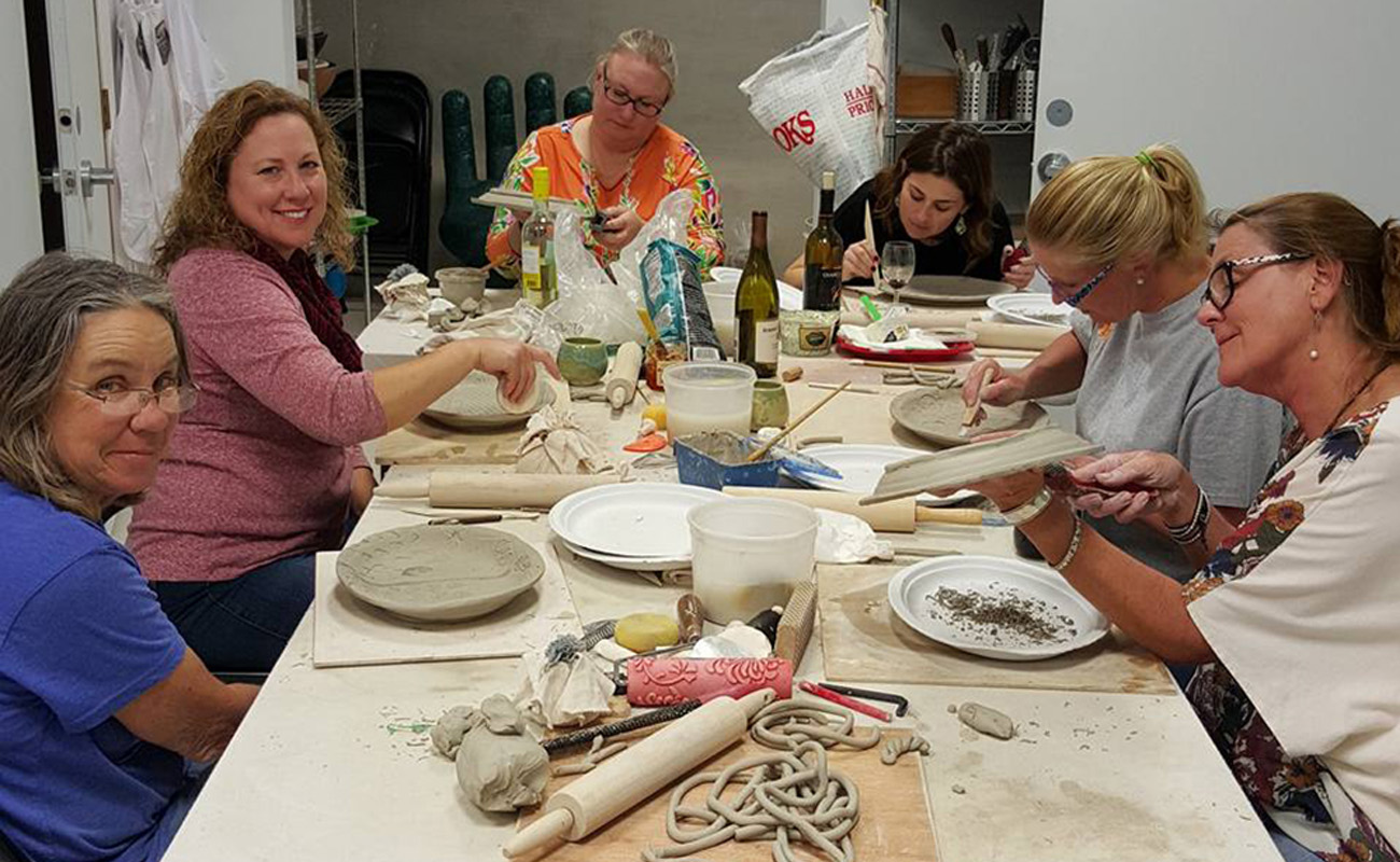 Women working on art clay projects at table